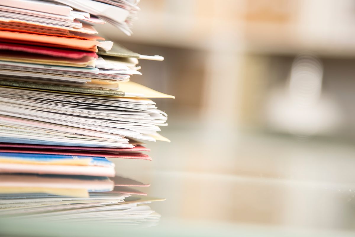 A stack of documents on a desk to help illustrate this blog on fact finding hearings.